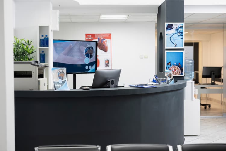 Empty reception desk and waiting area of a medical clinic