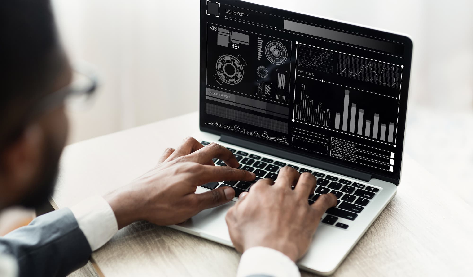 IT consultant reviewing infrastructure metrics on a laptop dashboard