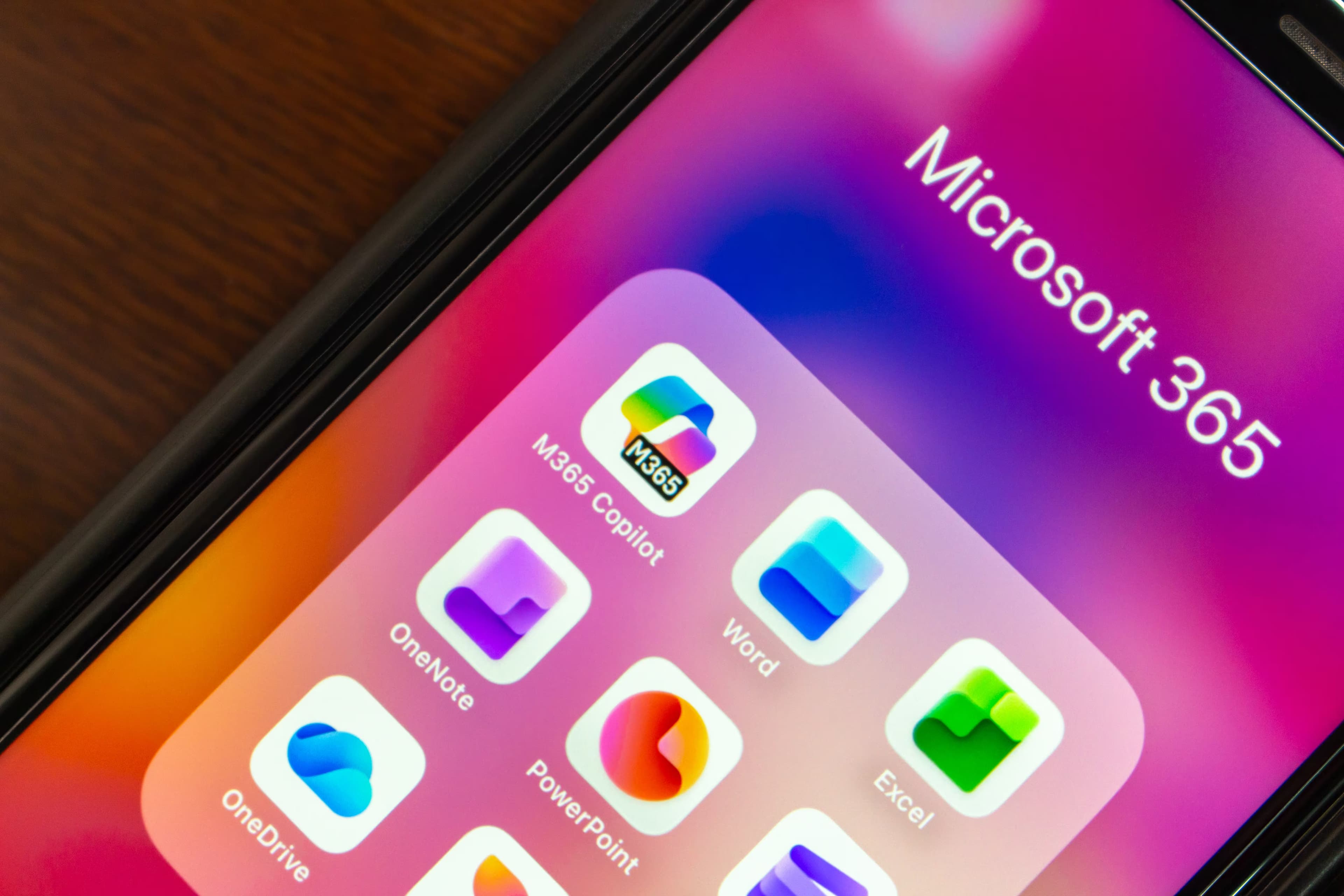 Smartphone home screen showing Microsoft 365 apps including Word, Excel and OneDrive