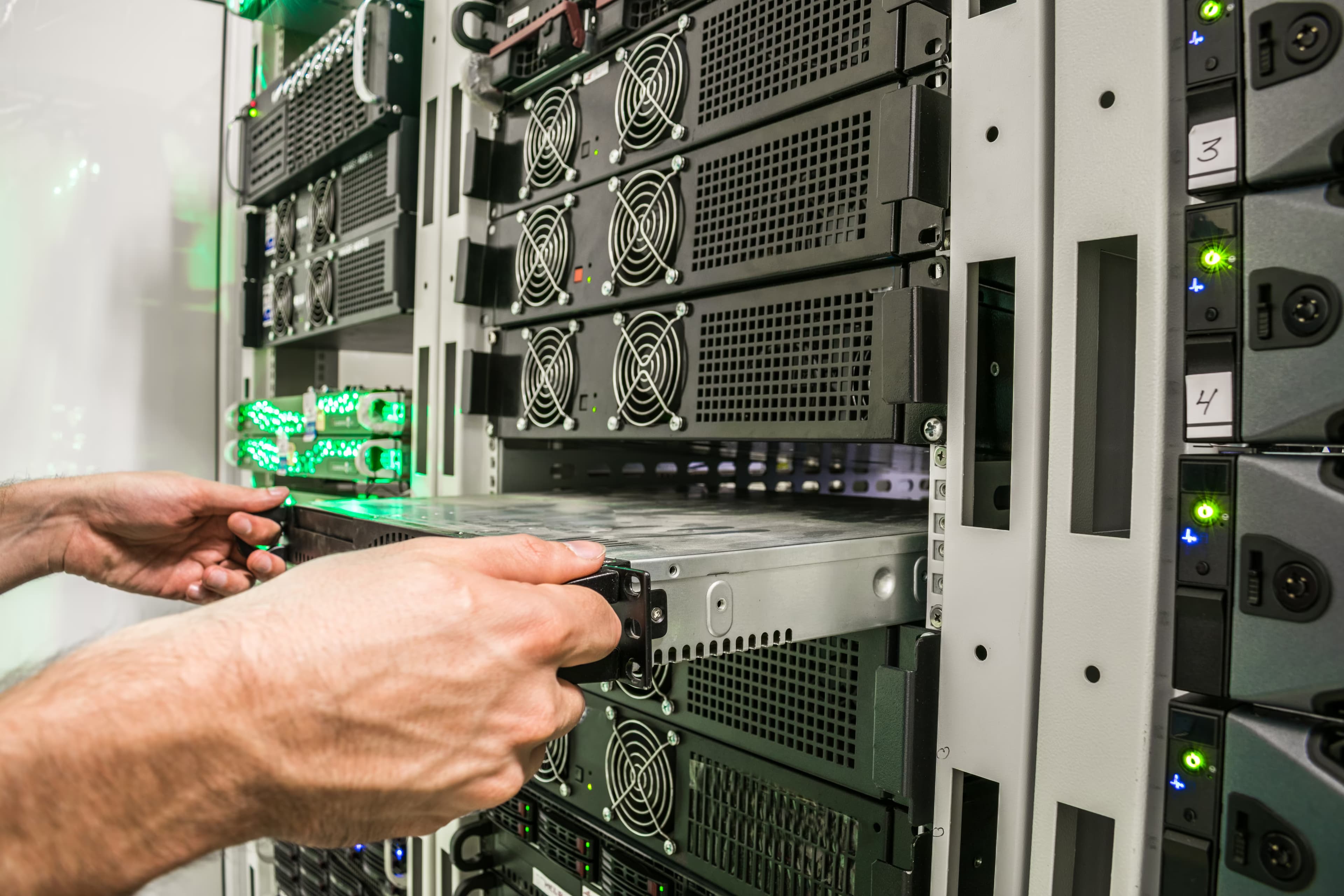 Technician sliding a server into a rack during go-live