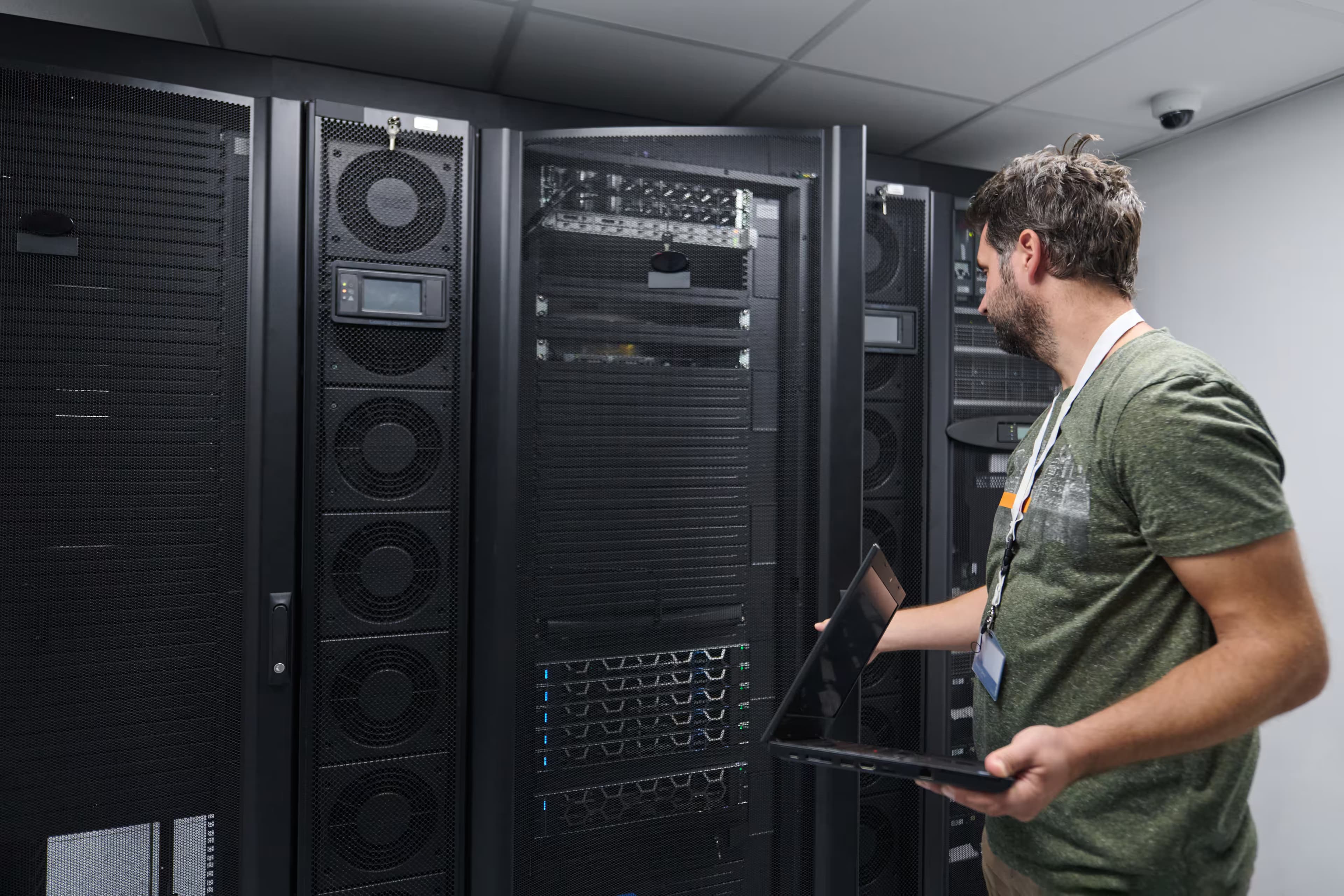 IT engineer with a laptop checking equipment in a server room