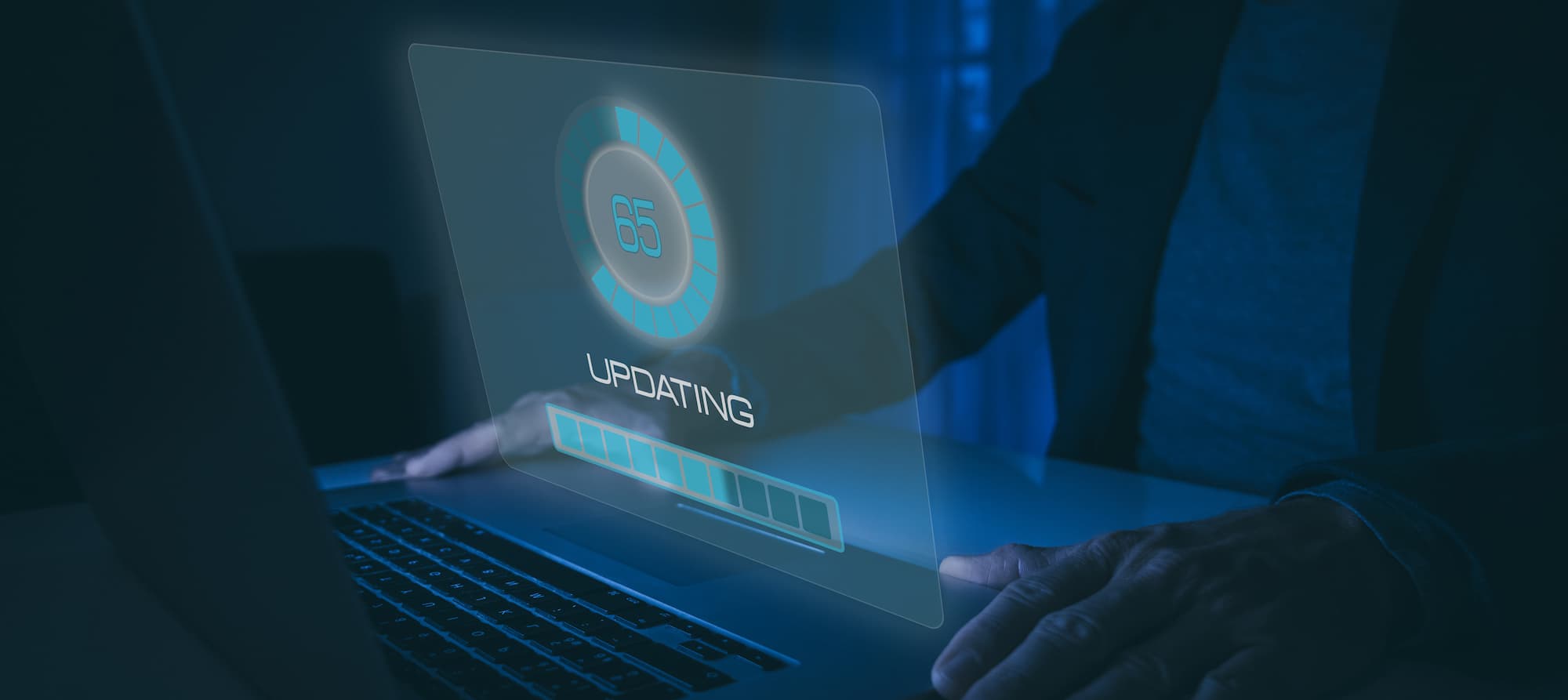 Engineer at a laptop showing a firmware update progress indicator