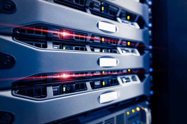 Server racks in a data centre with red status lighting