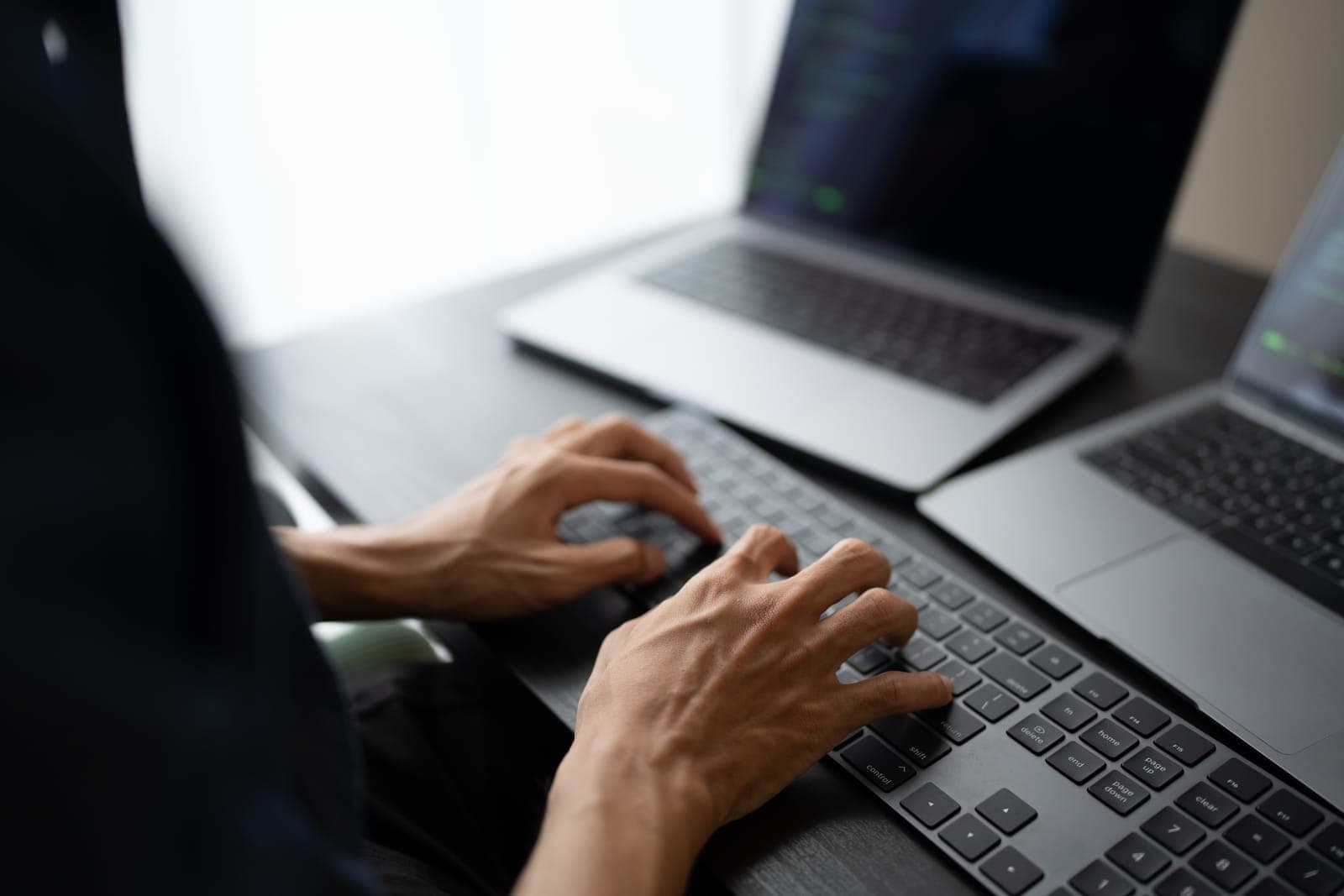 IT technician typing on a laptop